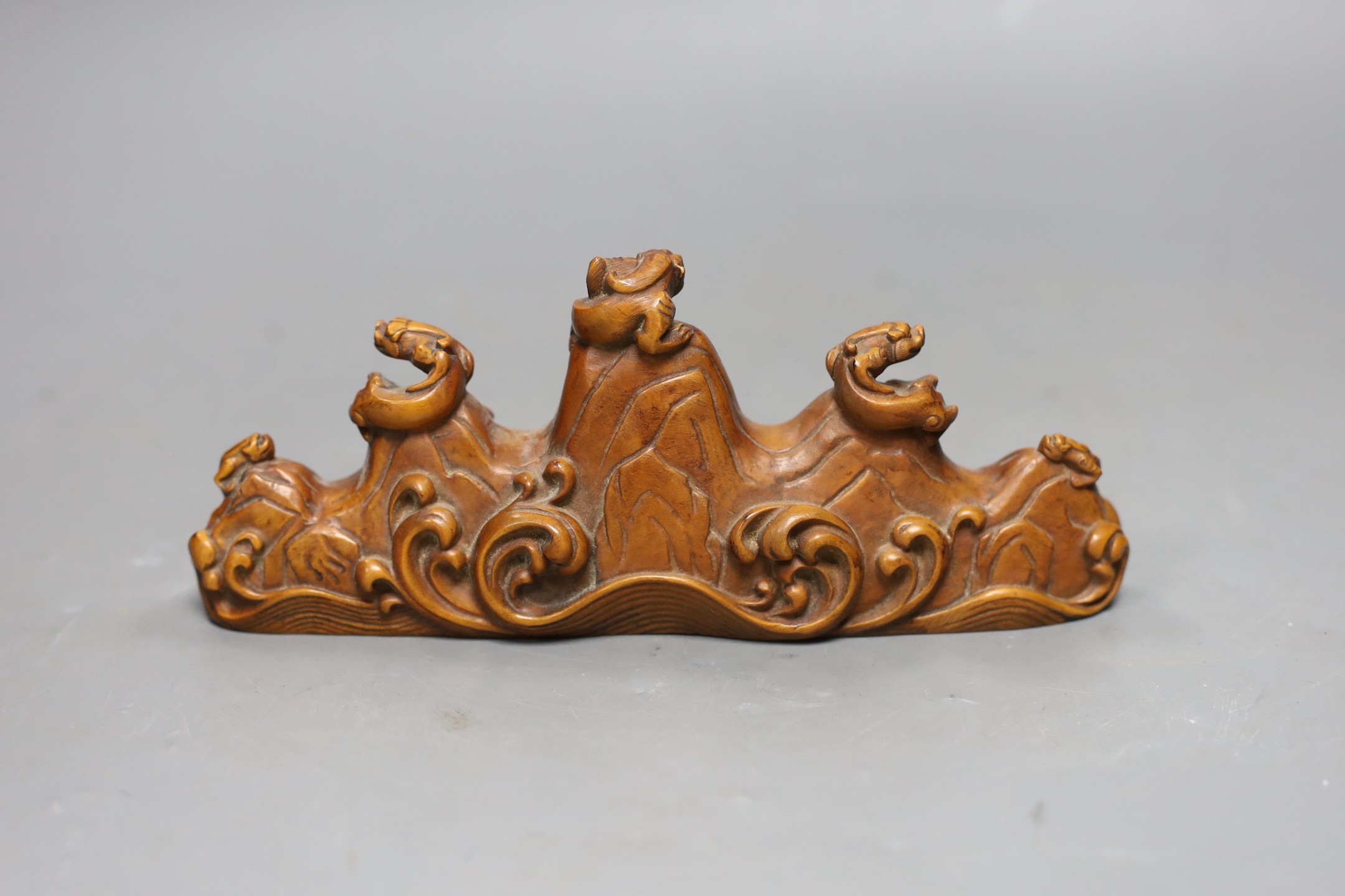 A Chinese carved wood brush rest, 18cms wide
